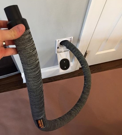 This central vac hose will hide in the wall after use